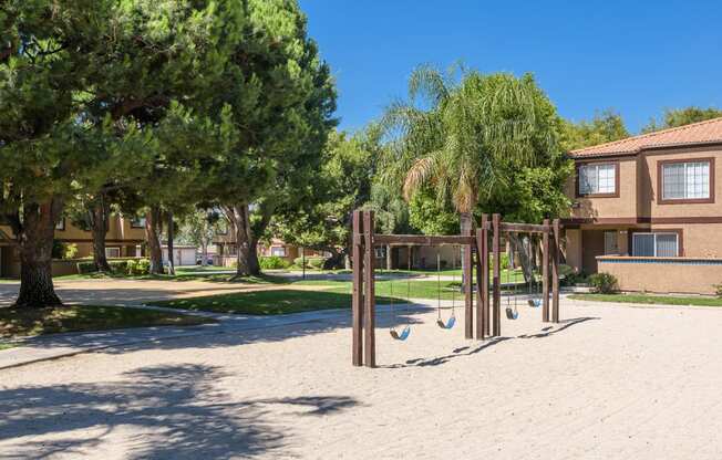 a playground in a park in front of a building