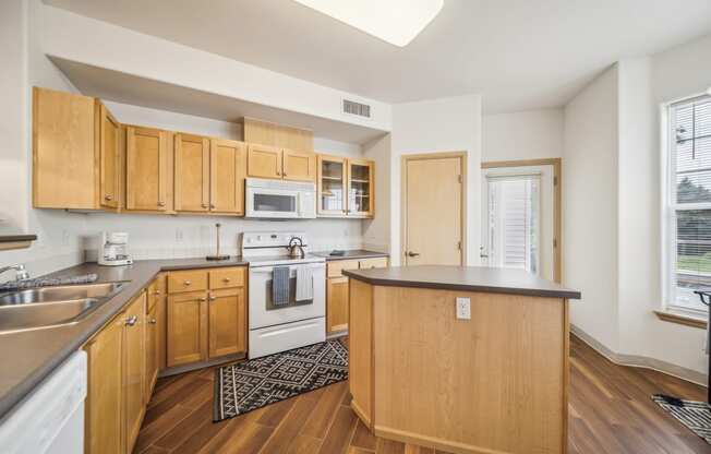 a kitchen with wooden cabinets and appliances and a counter top