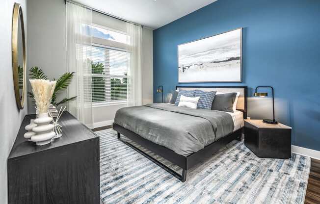 a bedroom with a bed and a large window at The Overlook, Winter Garden