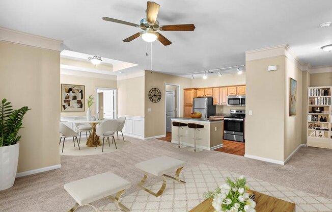 a living room and kitchen with a ceiling fan