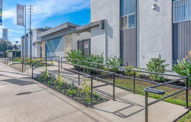 a building with stairs and plants in front of itat BLVD Apartments LLC, California