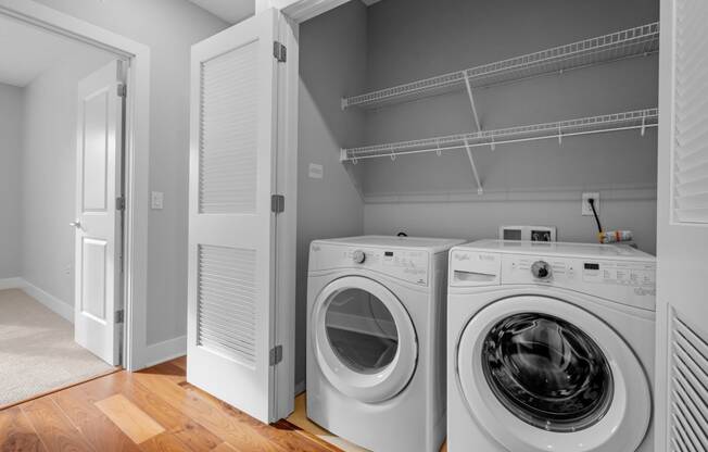 a washer and dryer in a laundry room with a closet