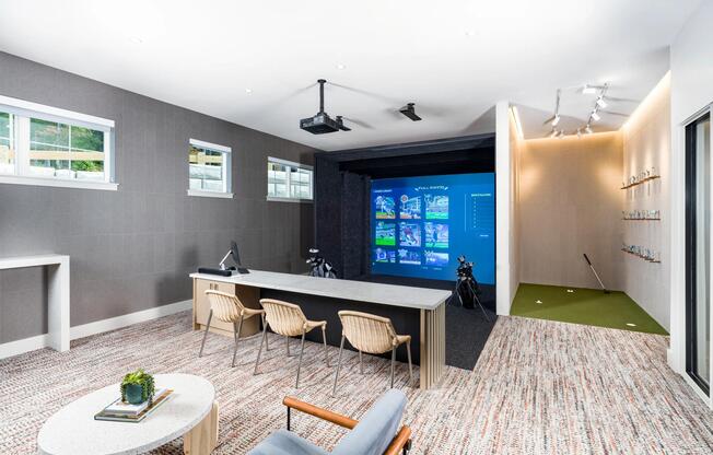 Perfect your swing year-round in the golf simulator lounge, complete with a putting green and comfortable seating for spectators.