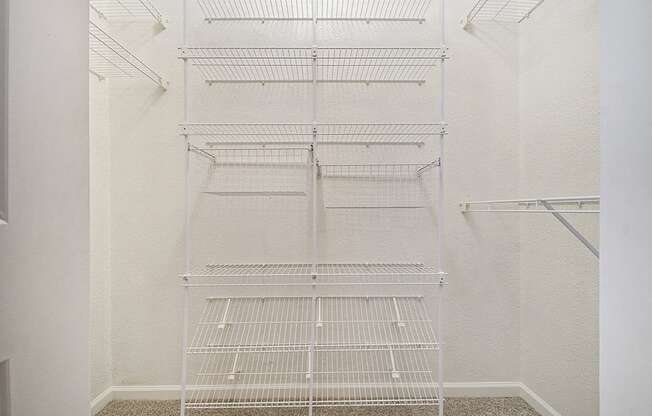 A walk in closet with wardrobe organizers at Lynbrook Apartments and Townhomes, Elkhorn, NE, 68022