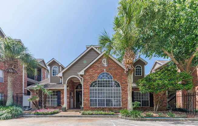 A house with a brick facade and a large arched window.