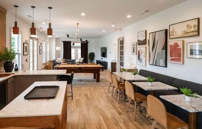 A modern kitchen and dining area with wooden floors and furniture.