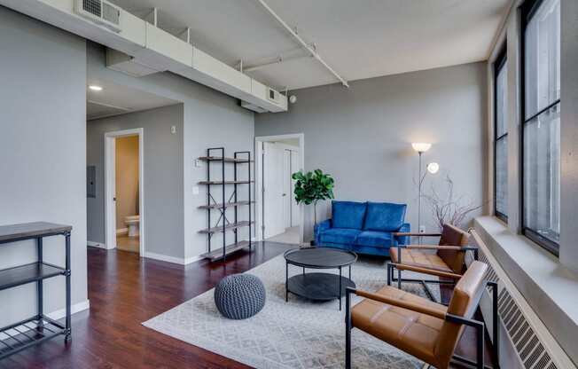 an open living room with a blue couch and a coffee table