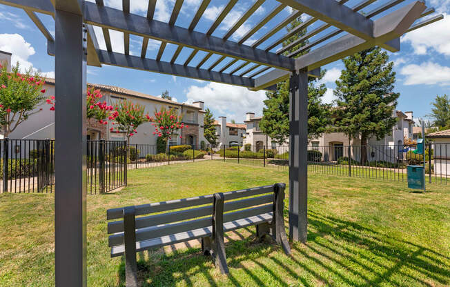 Our gated dog park features a semi-shaded gazebo and comfortable seating, creating a relaxing space for pet owners while their dogs play and socialize at Ascent at the Galleria.