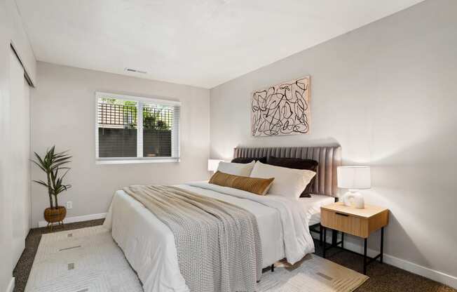 The Grove Apartments bedroom with large bed and night stands