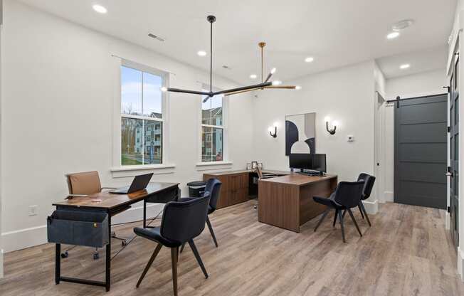 Conference room with desks and chairs and a large window at Hadley Place Apartments, Pennsylvania