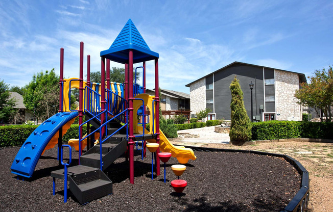 a playground at a school with a building in the background