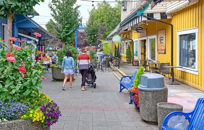 a couple of people walking down a sidewalk with a stroller at Woodcreek, Washington