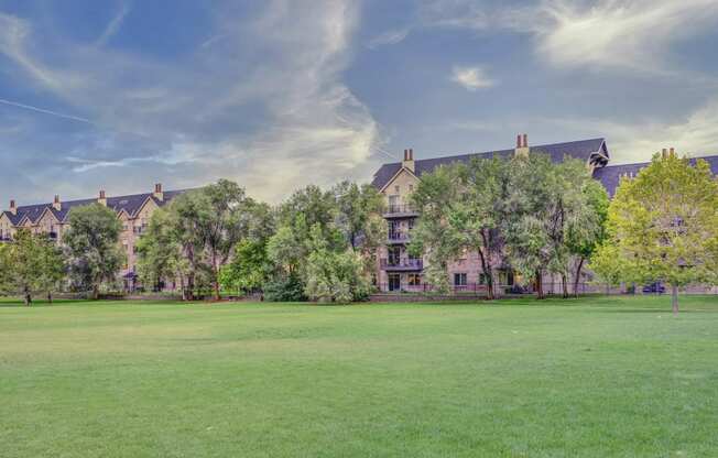 Exterior of apartment buildings with trees and grassy field