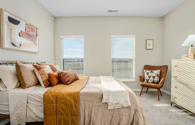 a bedroom with a bed and two windows