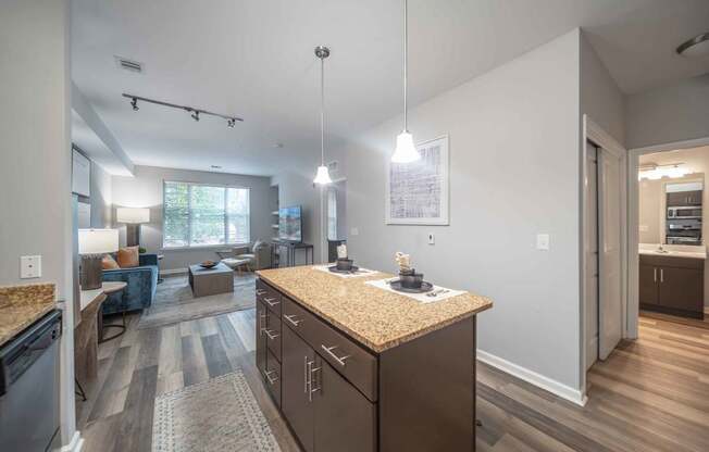 a kitchen with wooden cabinets and granite countertops at Harbor Pointe in Bayonne, NJ