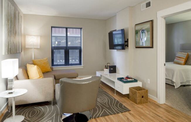 a living room with a couch and a chair and a television