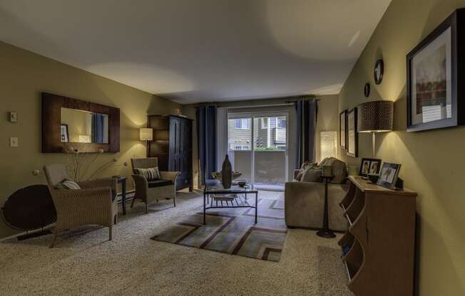 Arnada Pointe living room with a couch and chairs and a tv