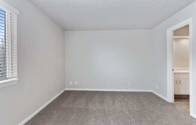 an empty room with white walls and a window at Eastwood Crossings, Missouri