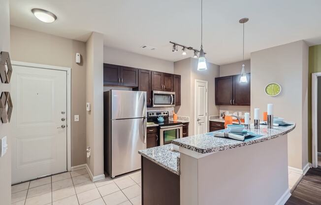 a kitchen with stainless steel appliances and a granite counter top