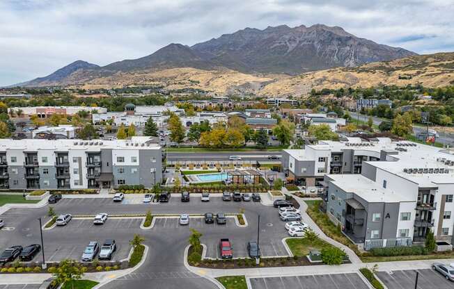 an aerial view of an apartment complex with a mountain in the background