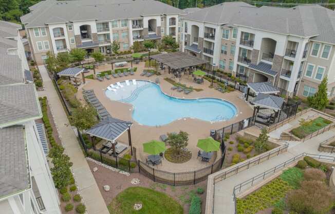 an aerial view of an apartment complex with a large swimming pool