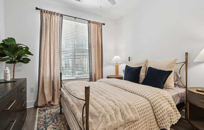 a bedroom with a bed and a large window