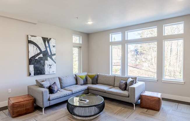 A living room with a grey couch and a coffee table.