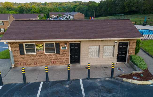 a view of the front of a brick building with a parking lot