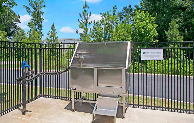 a stainless steel barbecue grill in front of a gate