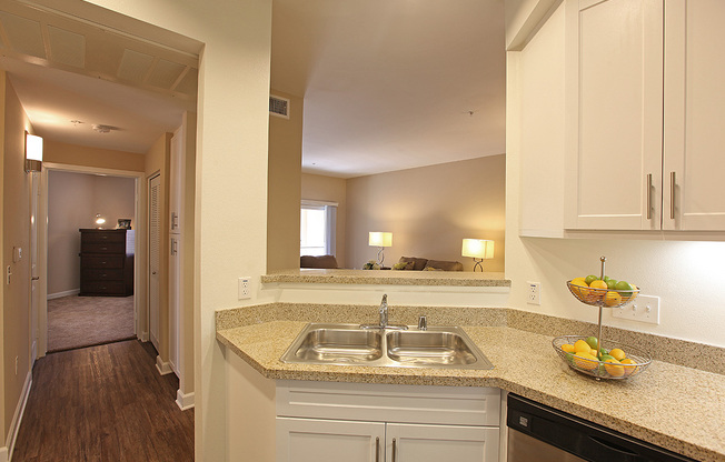 a kitchen with a sink and a mirror