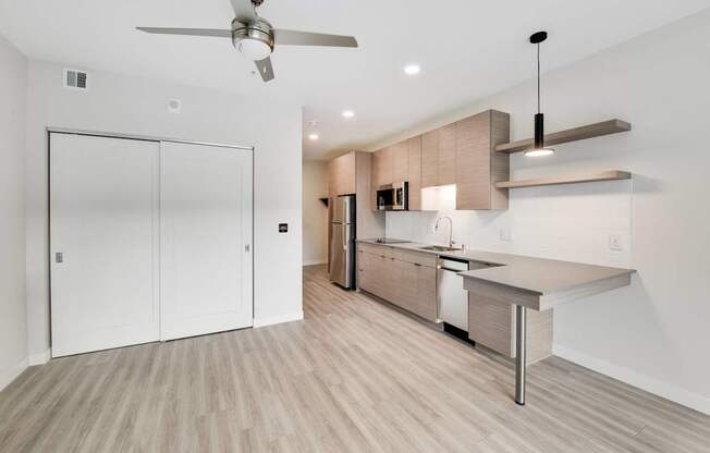 A modern kitchen with a fan on the ceiling.