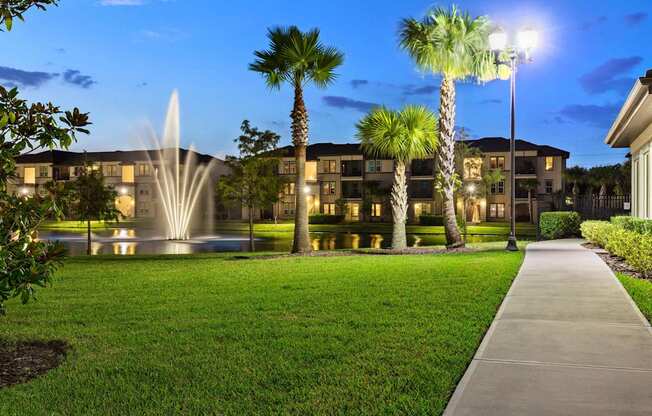 A building with a fountain in front of it.