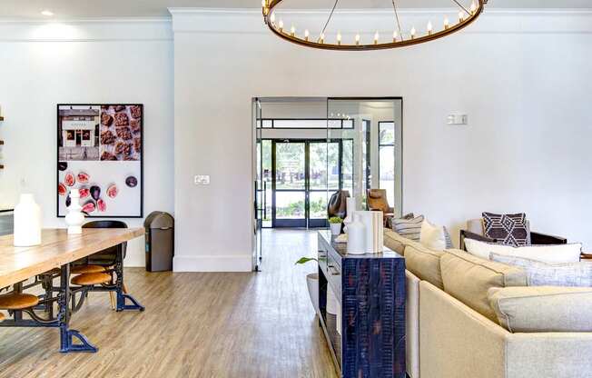 A living room with a white couch and a wooden table.