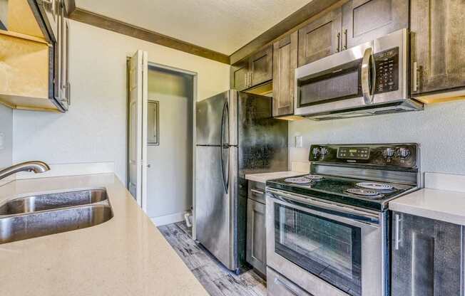 a kitchen with stainless steel appliances and a sink