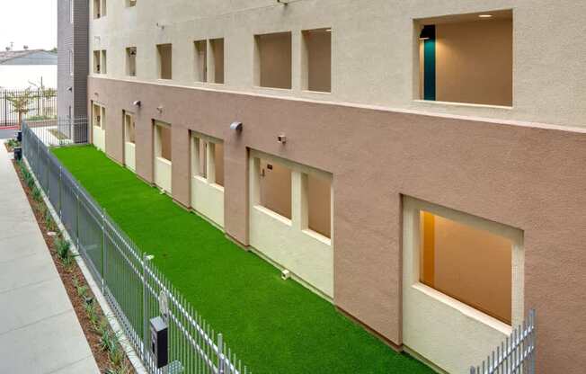 A building with a green lawn in front.