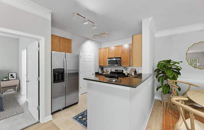 A modern kitchen with wooden cabinets and stainless steel appliances.