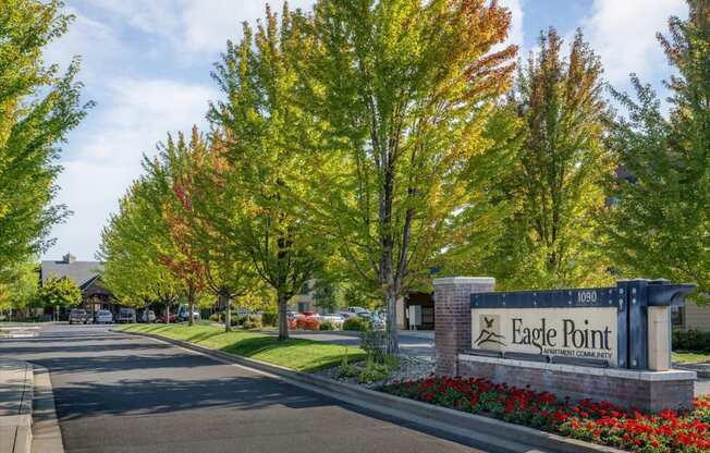 the entrance to eagle pointe in front of trees and flowers