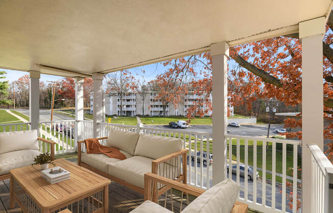 A white porch with a table and chairs.