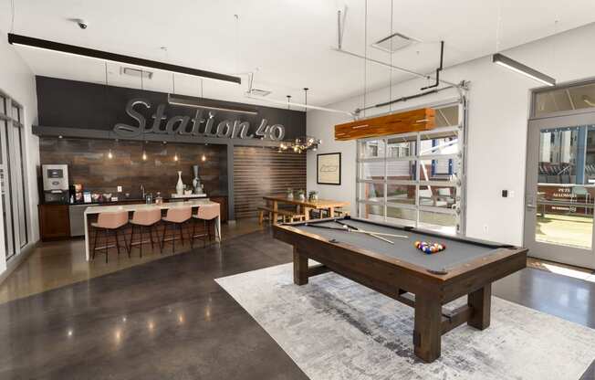 a game room with a pool table and a bar
