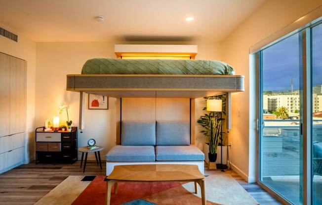 a loft bed in a room with a couch and a table