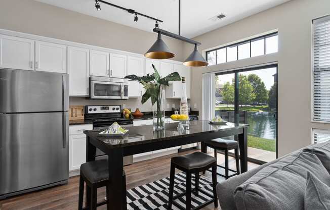 an open kitchen and living room with a stainless steel refrigerator at Hayden Lofts, Ohio
