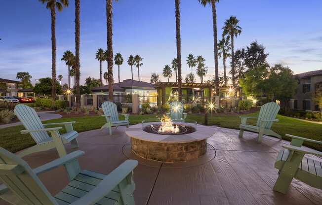 Estancia at Mission Grove Apartments Fire pit at night