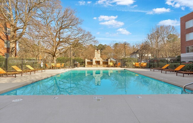 Unwind by the stunning pool at Icon Downtown Durham, surrounded by serene landscaping and vibrant skies. Enjoy relaxation and leisure in this beautiful setting. Your ideal retreat awaits—schedule a visit today!