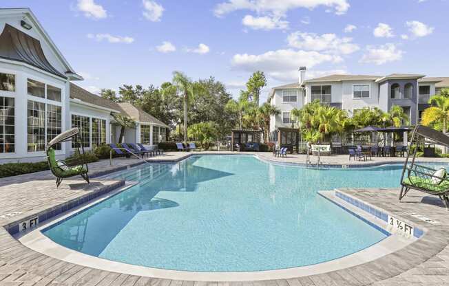 a large swimming pool with houses in the background