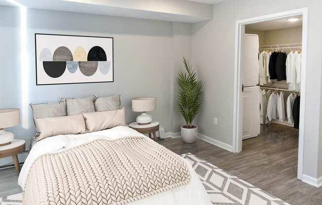 A bedroom with a large bed and a painting on the wall.