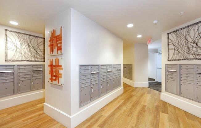 a room with a bunch of lockers and a painting on the wall