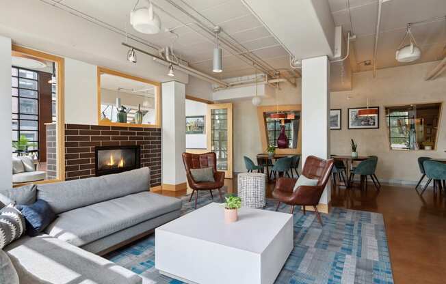 a living room with couches chairs and a fireplace