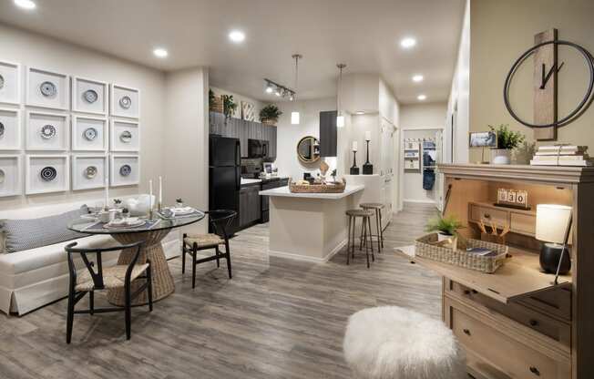 an open kitchen and living room with a table and chairs