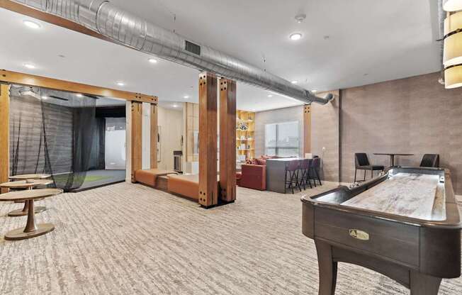 a game room with a pool table and a bar