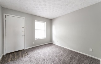 an empty room with carpet and a door